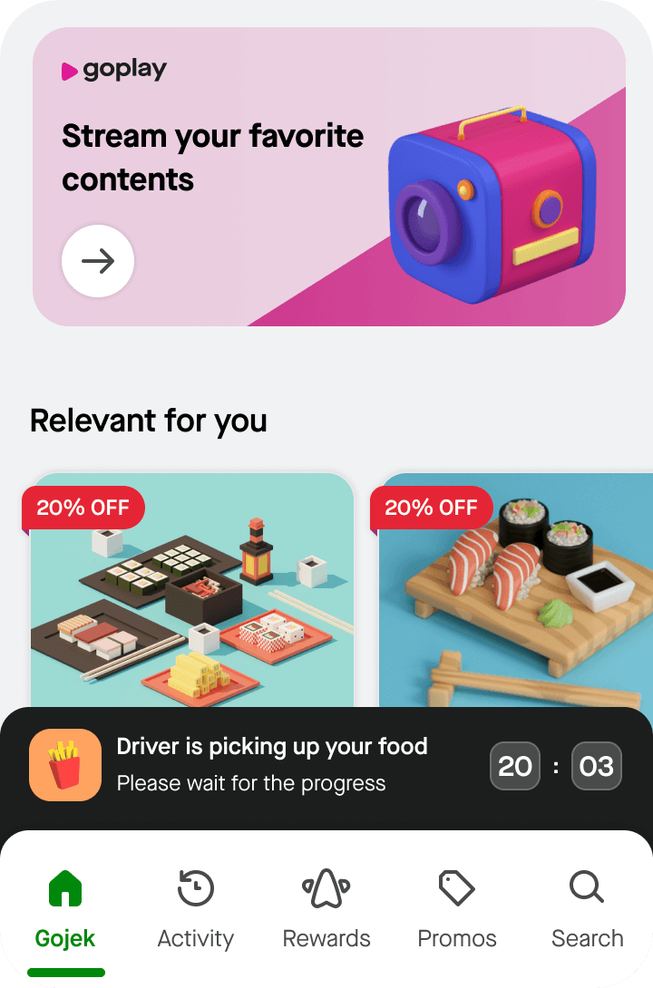 App home screen with a "goplay: Stream your favorite contents" banner, a "Relevant for you" section showing discounted food items, and a black "Driver is picking up your food" status bar
